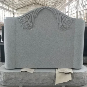 high relief lily carved granite tombstone