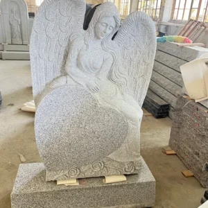a carved angel leaning against a heart