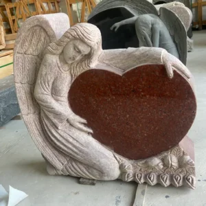 red sculpted angel holding heart monument