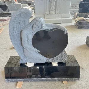 single heart with sculpted angel monument